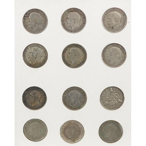 2104 - A collection of George V silver threepence pieces housed in a plastic display case.