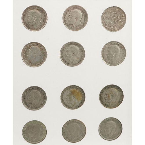 2104 - A collection of George V silver threepence pieces housed in a plastic display case.