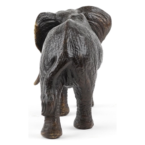 1567 - A Japanese patinated bronze okimono of a bull elephant, 31cm in length.