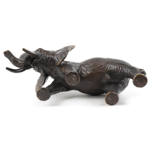 1567 - A Japanese patinated bronze okimono of a bull elephant, 31cm in length.