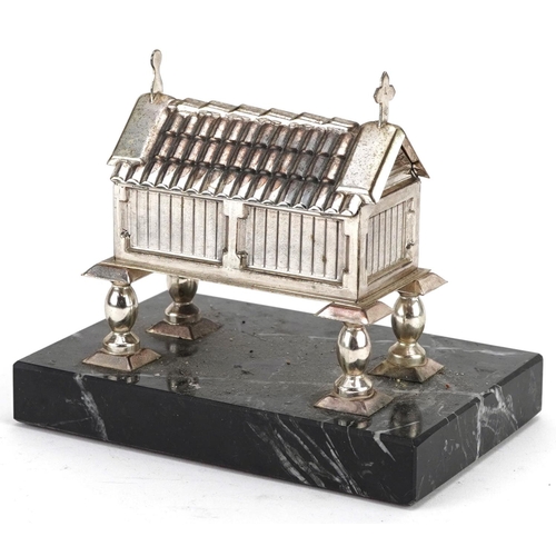 474 - White metal trinket box with hinged lid in the form of a church raised on a black marble base, the l... 