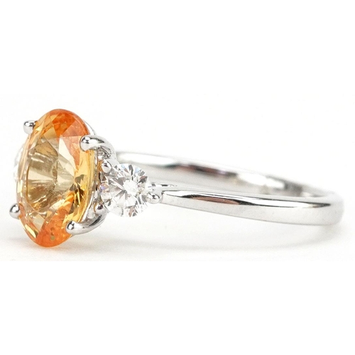 3037 - An 18ct white gold orange sapphire and diamond three stone ring, the sapphire approximately 2.22 car... 