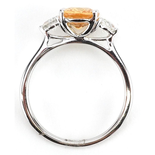 3037 - An 18ct white gold orange sapphire and diamond three stone ring, the sapphire approximately 2.22 car... 