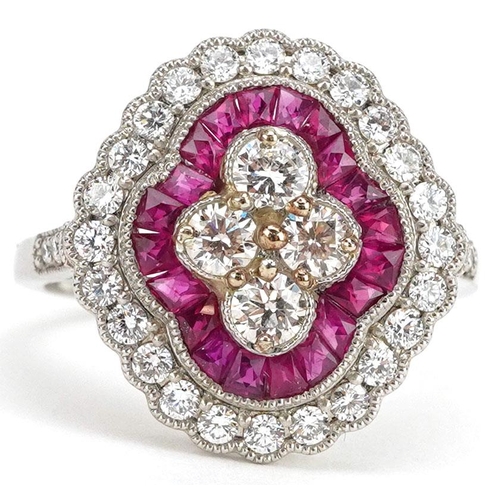  A Victorian style platinum, ruby and diamond three tier cluster ring, total diamond weight approxima... 