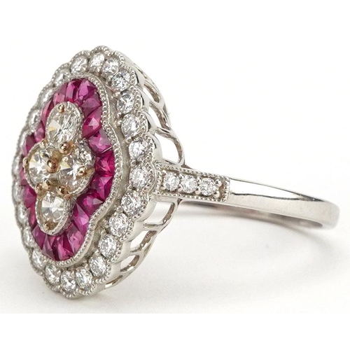  A Victorian style platinum, ruby and diamond three tier cluster ring, total diamond weight approxima... 