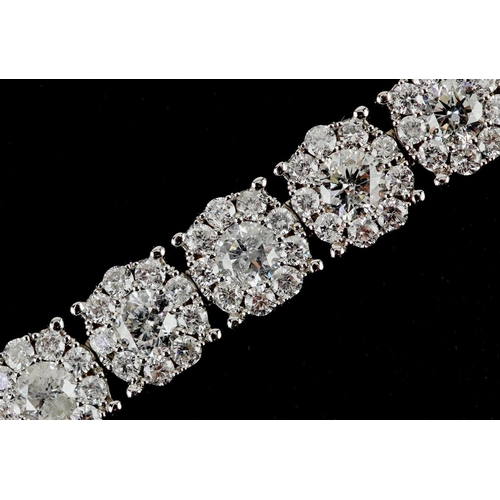 14ct white gold diamond cluster line bracelet, total diamond weight approximately 10.0 carat, 19cm in length, 21.2g, with certificate.