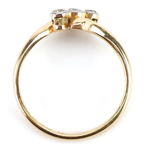 3054 - An 18ct gold diamond three stone crossover ring, the central diamond approximately 2.70mm in diamete... 