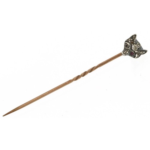 3041 - An antique unmarked gold hunting interest stickpin in the form of a fox head set with diamonds and r... 