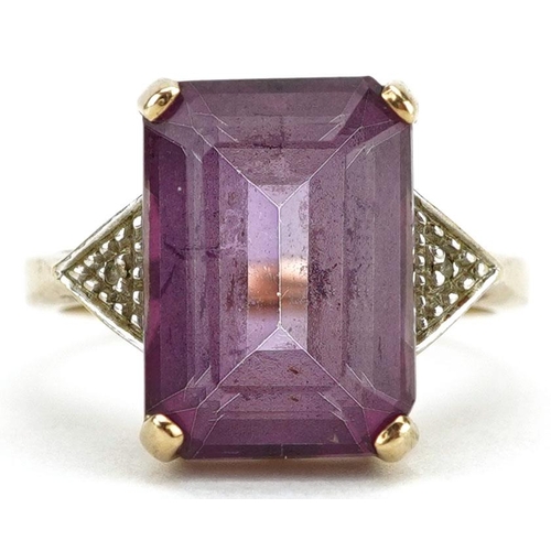 3067 - A 9ct gold rectangular cut pink topaz ring with diamond set shoulders, the topaz approximately 14.15... 