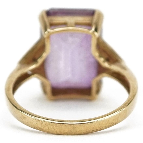 3067 - A 9ct gold rectangular cut pink topaz ring with diamond set shoulders, the topaz approximately 14.15... 