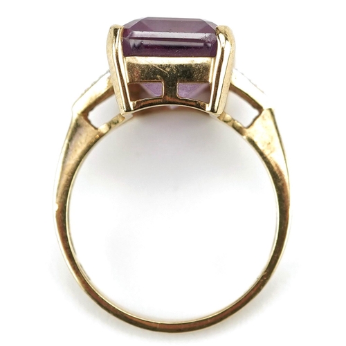 3067 - A 9ct gold rectangular cut pink topaz ring with diamond set shoulders, the topaz approximately 14.15... 