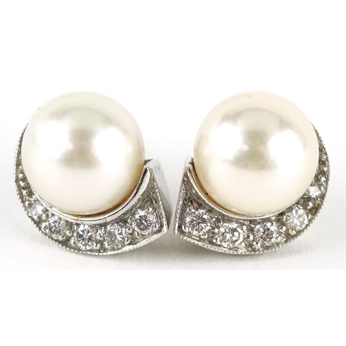 3015 - A pair of unmarked white gold cultured pearl and diamond stud earrings, the pearls 8.2mm in diameter... 