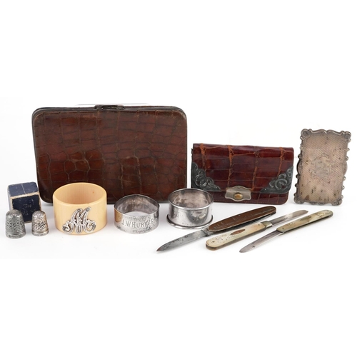 91 - A small group of mixed silver items including a Victorian card case, two napkin rings, two mother of... 