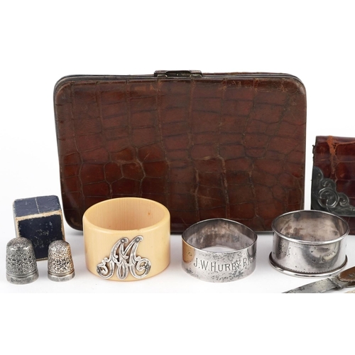 91 - A small group of mixed silver items including a Victorian card case, two napkin rings, two mother of... 