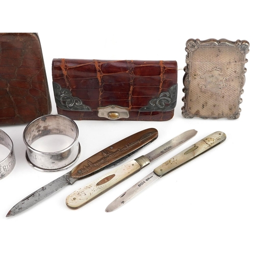 91 - A small group of mixed silver items including a Victorian card case, two napkin rings, two mother of... 