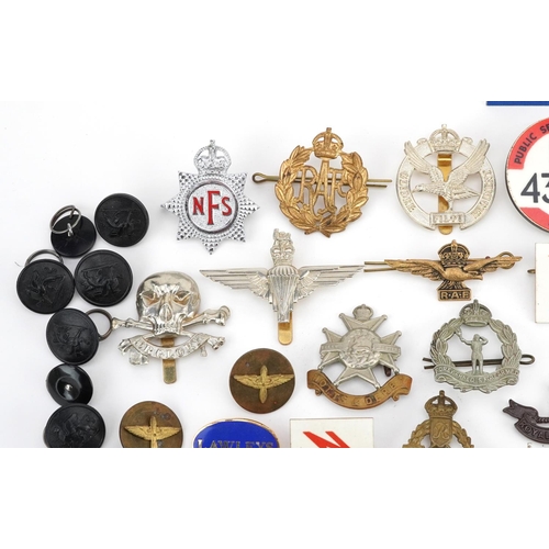 2471 - A mixed group of military badges and buttons to include a silver ARP cap badge, some reproductions.