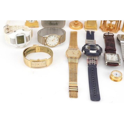 3338 - A collection of miniature gilt brass clocks and wristwatches including Accurist, Limit and Harrods.