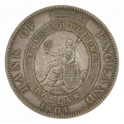 2048 - A George III 1804 Bank of England silver five shillings/silver trade dollar, engraved on the obverse... 