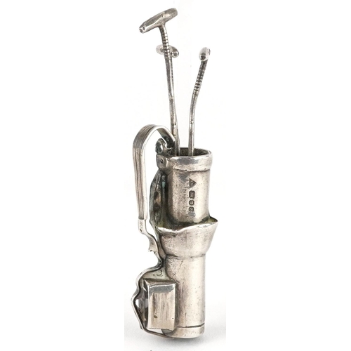 487 - A miniature silver study of a golf caddy with golf clubs, London 1989, 6.5cm high, 19.2g