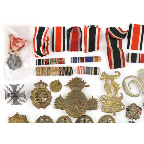 2474 - A collection of militaria including Bavarian helmet plate, German medal ribbons, cloth patches and u... 