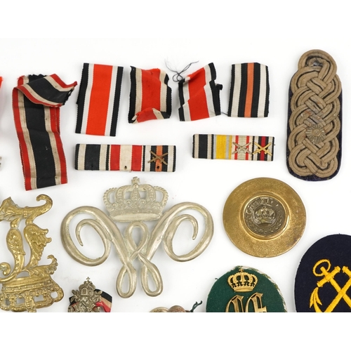 2474 - A collection of militaria including Bavarian helmet plate, German medal ribbons, cloth patches and u... 