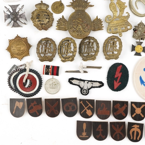 2474 - A collection of militaria including Bavarian helmet plate, German medal ribbons, cloth patches and u... 