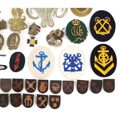 2474 - A collection of militaria including Bavarian helmet plate, German medal ribbons, cloth patches and u... 