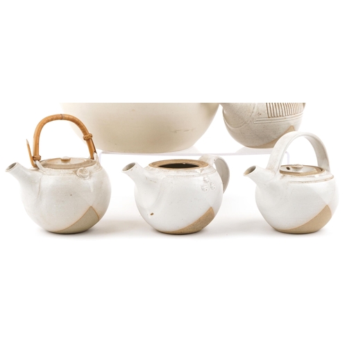 1560 - A group of four 20th century white glazed studio pottery teapots (one lacking lid) together with a w... 