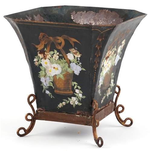 1550 - An early 20th century tole painted metal planter decorated with flowers raised on scroll supports, H... 