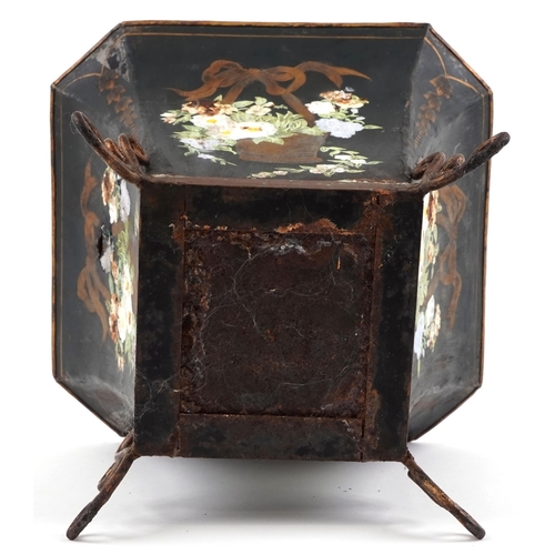 1550 - An early 20th century tole painted metal planter decorated with flowers raised on scroll supports, H... 