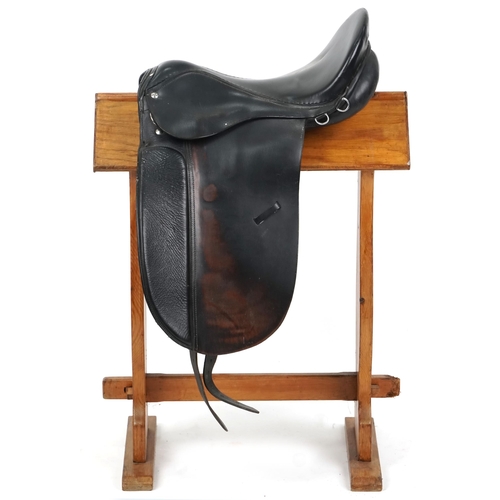 1143 - A dark brown leather 18 inch saddle.