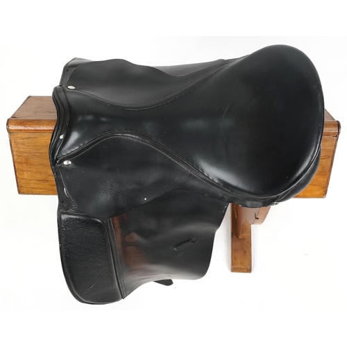 1143 - A dark brown leather 18 inch saddle.