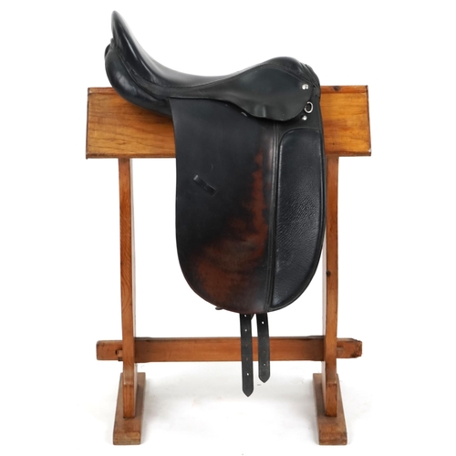 1143 - A dark brown leather 18 inch saddle.