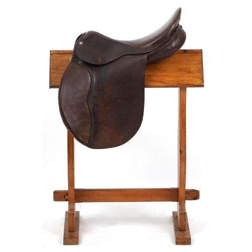 1145 - An Equestrian Manufacturing and Supply brown leather 16 inch saddle.