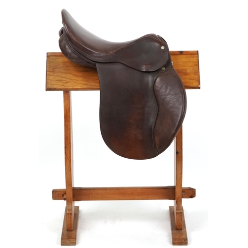 1145 - An Equestrian Manufacturing and Supply brown leather 16 inch saddle.