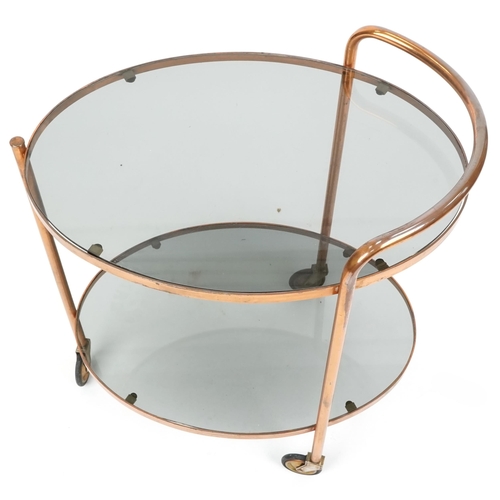 1106 - A mid 20th century two tier tea trolley with smokey glass, H-73cm W-62cm