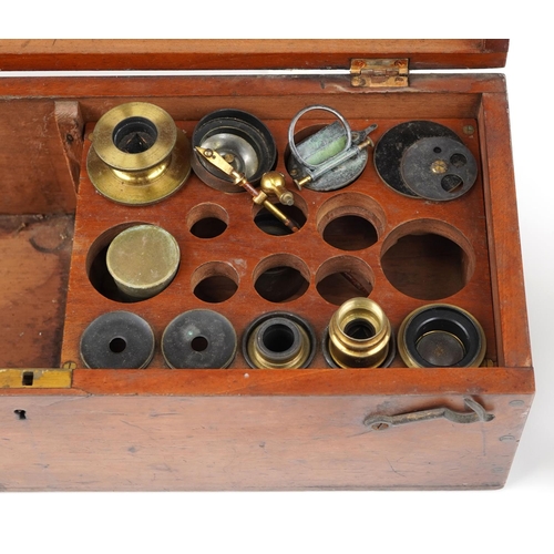 137 - A brass cased microscope by R. & J. Beck, London, no. 4711, in a fitted mahogany box, with a variety... 