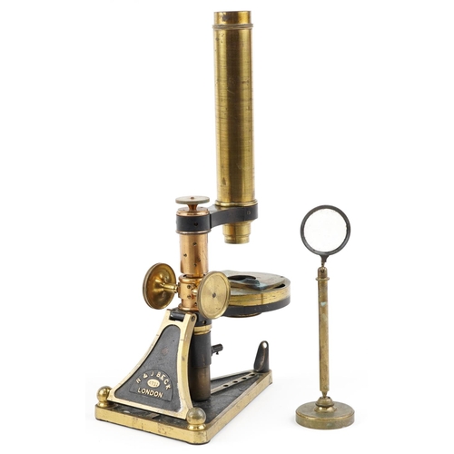 137 - A brass cased microscope by R. & J. Beck, London, no. 4711, in a fitted mahogany box, with a variety... 