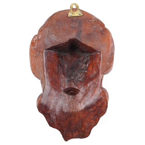 1589 - A Chinese carved wood wall mask of an elder with glass eyes, 23cm high.