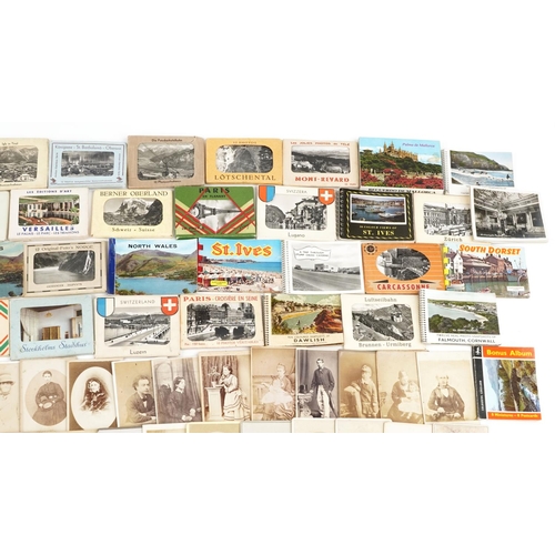 2256 - A collection of tourist travel photograph booklets together with a group of Victorian and later blac... 