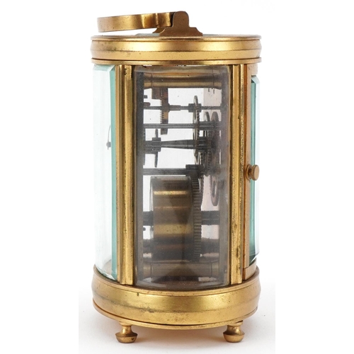 65 - Oval brass and bevelled glass carriage clock having enamelled dial with Arabic numerals, 12cm high