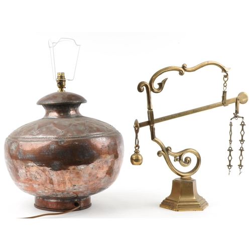 1552 - 20th century copper lamp base with embossed decoration, 45cm high, together with a brass shop's scal... 