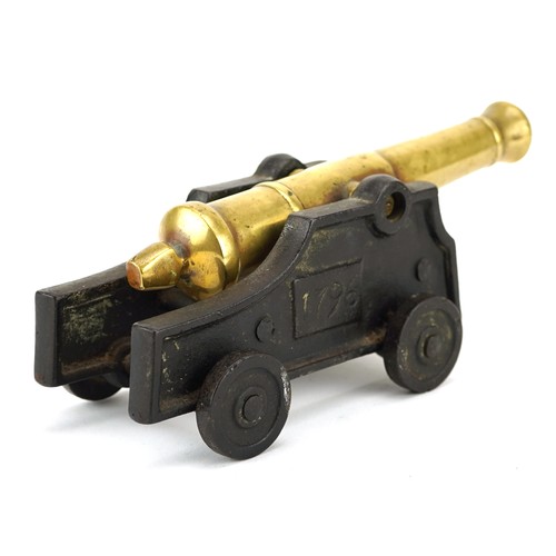 2452 - A 19th century cast iron and bronze model table cannon, 19cm in length