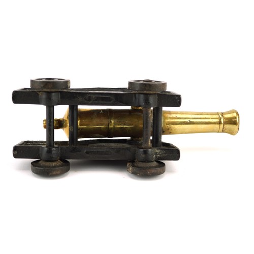 2452 - A 19th century cast iron and bronze model table cannon, 19cm in length