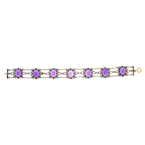 3030 - An antique unmarked filigree silver gilt bracelet set with seven cabochon amethyst stones and fourte... 