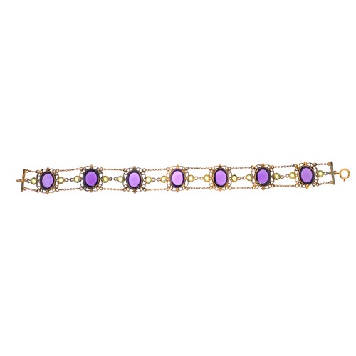 3030 - An antique unmarked filigree silver gilt bracelet set with seven cabochon amethyst stones and fourte... 