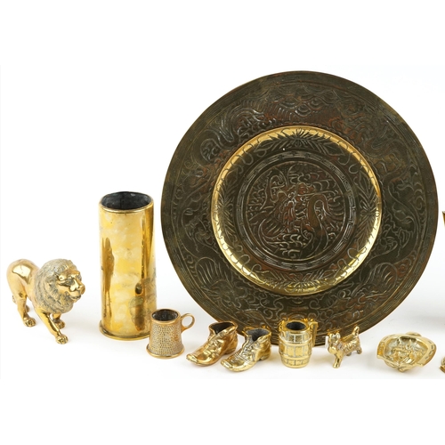 1301 - A small collection of 20th century brassware to include a charger, shell casing and a jug.