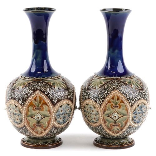 187 - A pair of Doulton Lambeth stoneware pottery bottleneck vases, 30cm high.