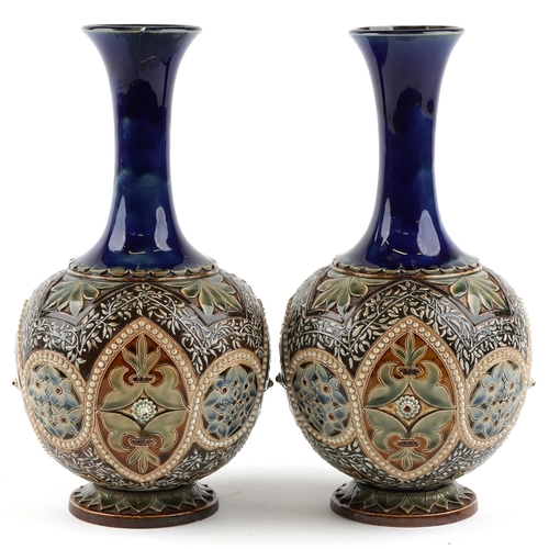 187 - A pair of Doulton Lambeth stoneware pottery bottleneck vases, 30cm high.