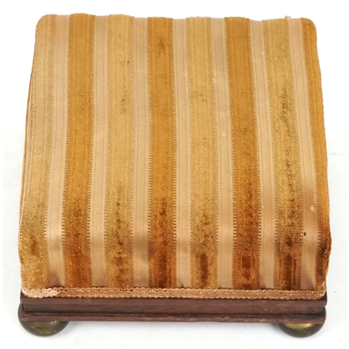 1148 - A 19th century walnut square footstool with brass bun feet, 31cm wide.